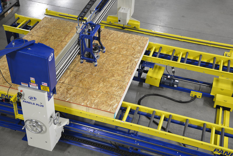 Panels Plus wall panel manufacturing equipment panelizing a wood wall panel.